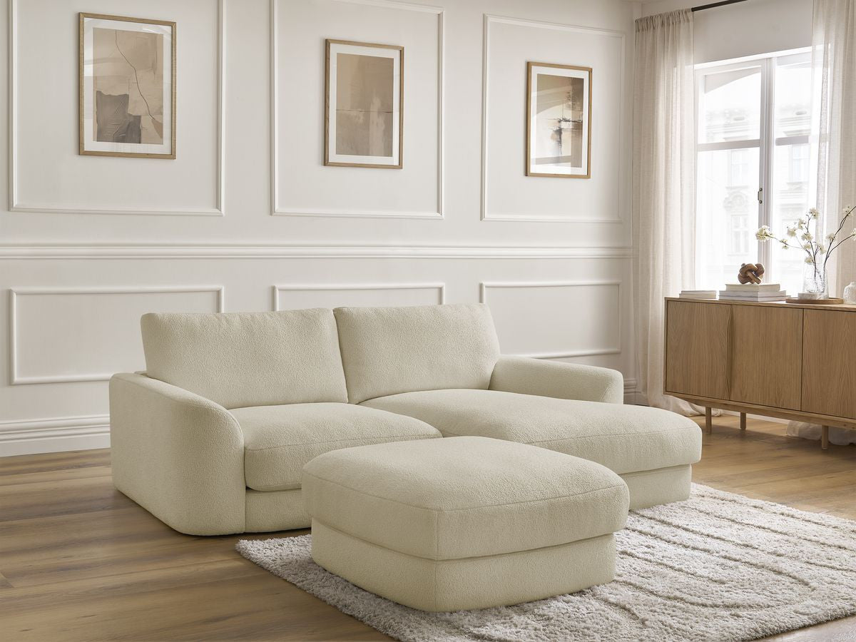 Hjørnesofa LEONORE i bouclé-stoff med puff